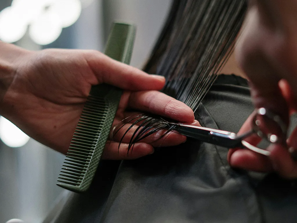 hairdresser cutting off hair ends